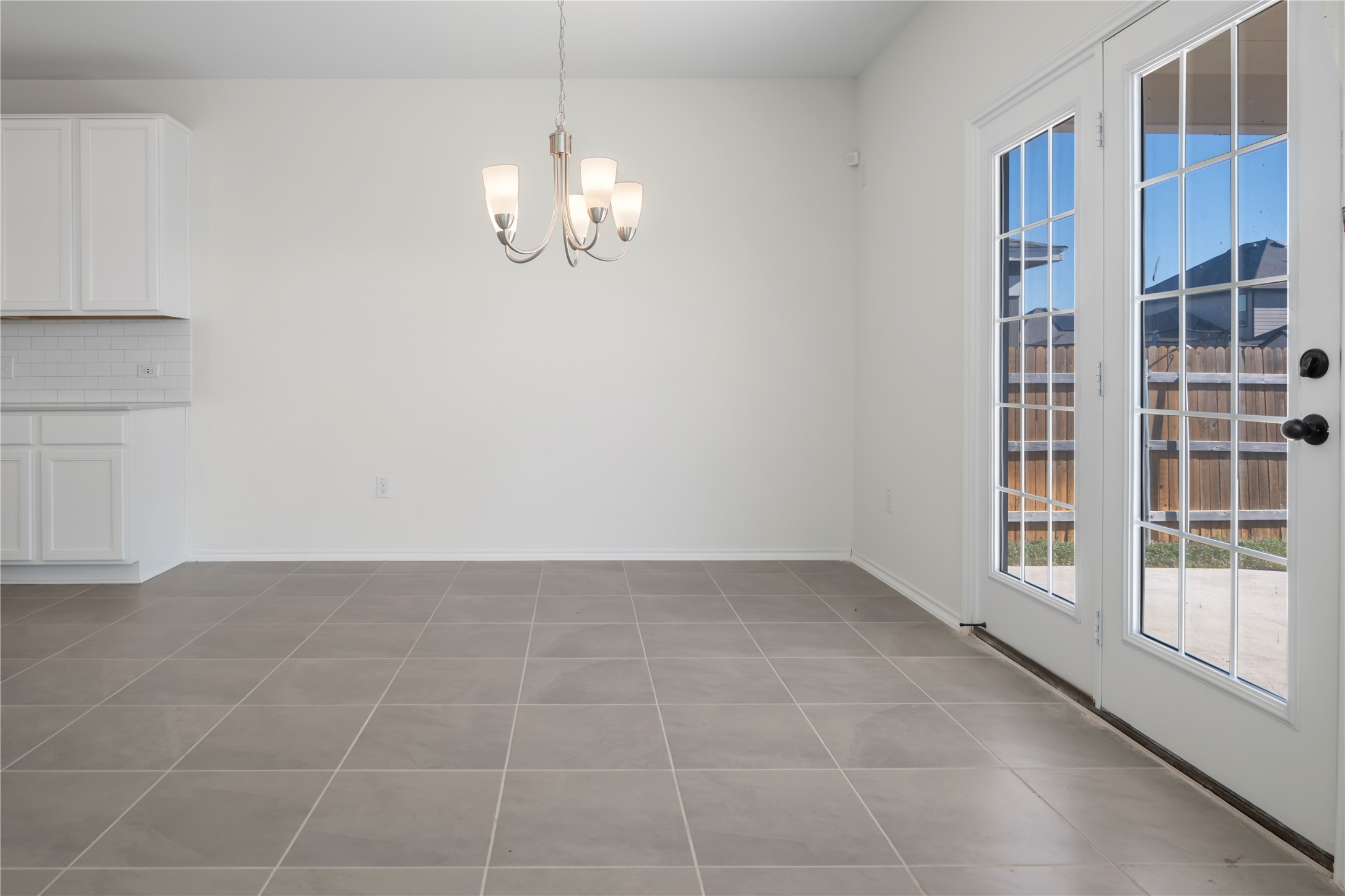 18501 Spotted Eagle Lane Elgin, TX 78621 - Photo 11 of 40 Unfurnished dining area with hanging lights and tile patterned floors