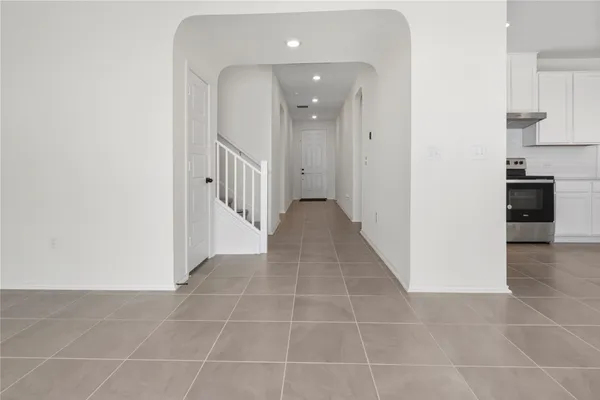 a view of a hallway with a kitchen