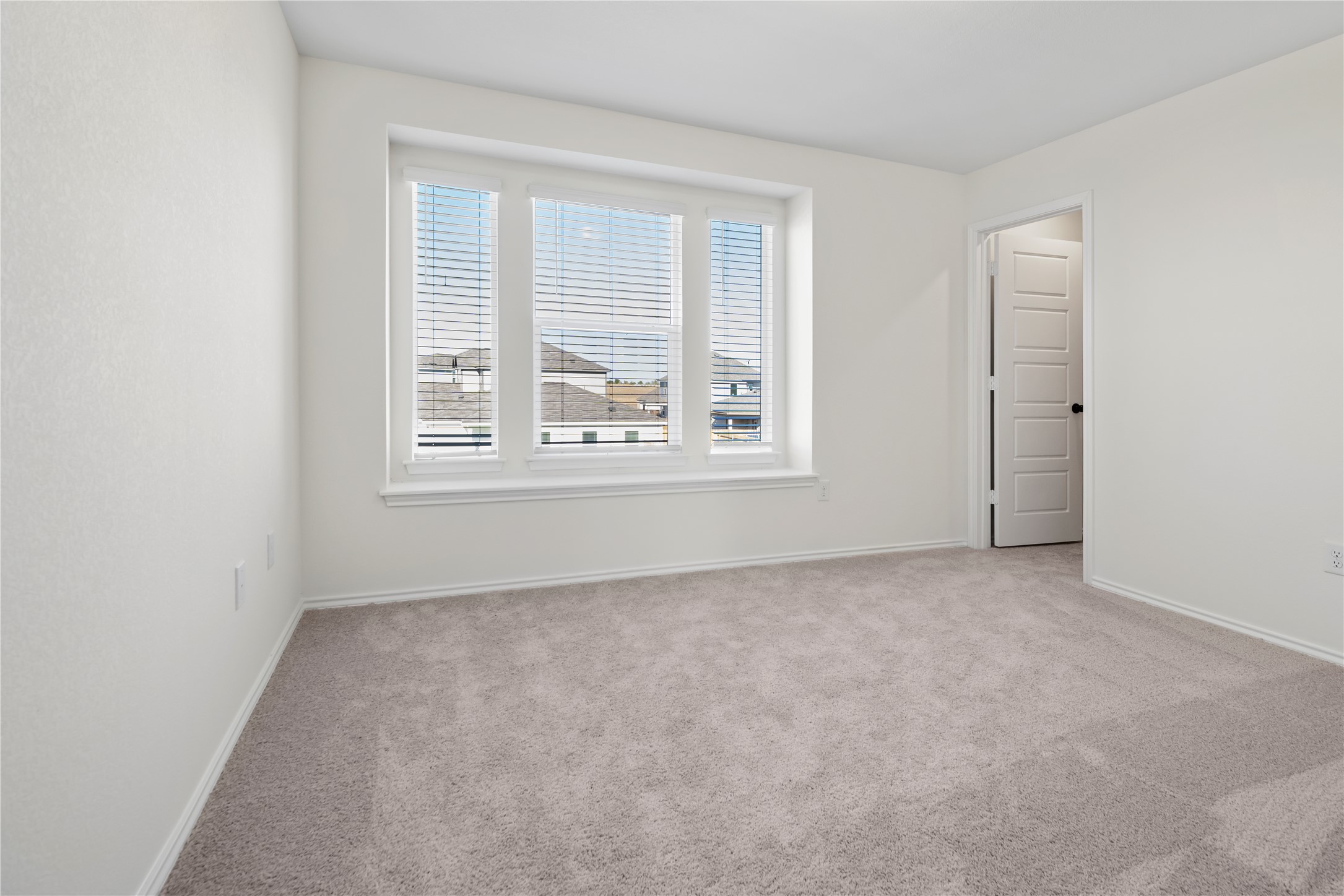 18501 Spotted Eagle Lane Elgin, TX 78621 - Photo 16 of 40 Spare room featuring light colored carpet and baseboards