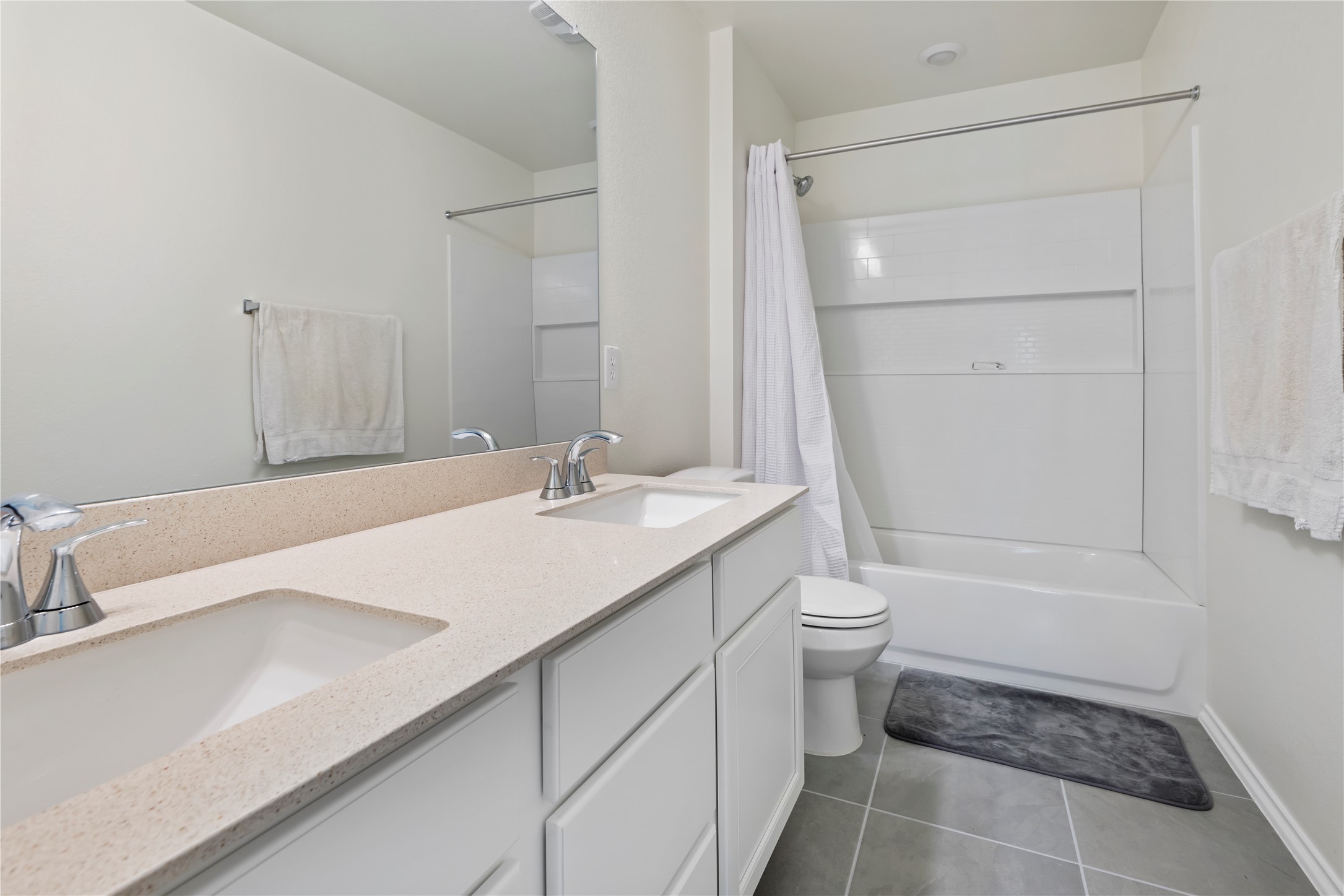 18501 Spotted Eagle Lane Elgin, TX 78621 - Photo 21 of 40 Full bathroom with shower / tub combo, double vanity, and dark tile patterned floors