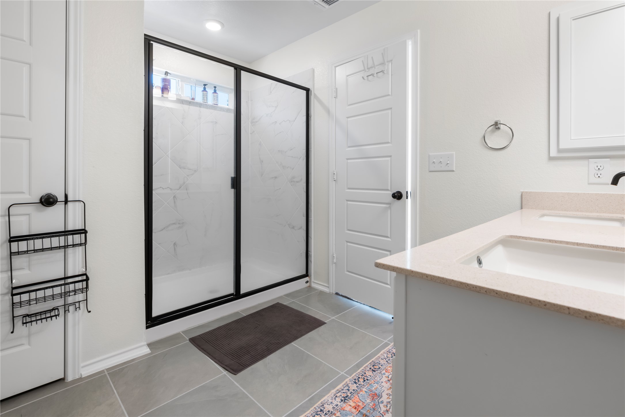 18501 Spotted Eagle Lane Elgin, TX 78621 - Photo 27 of 40 Full bath featuring double vanity, a marble finish shower, and light tile patterned flooring