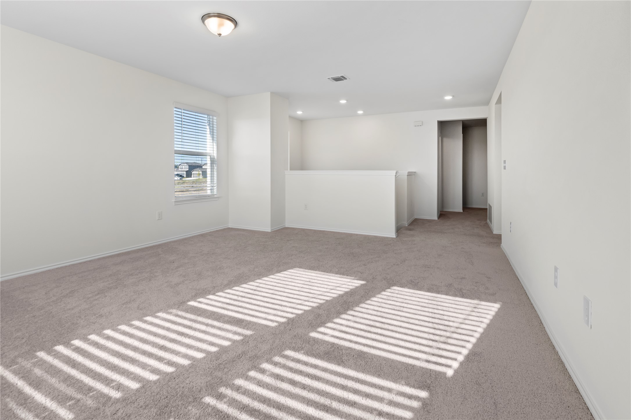 18501 Spotted Eagle Lane Elgin, TX 78621 - Photo 31 of 40 Empty room with carpet flooring and recessed lighting