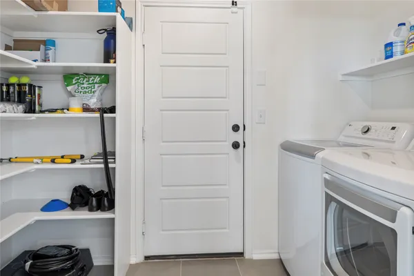 a view of storage and utility room with washer and dryer