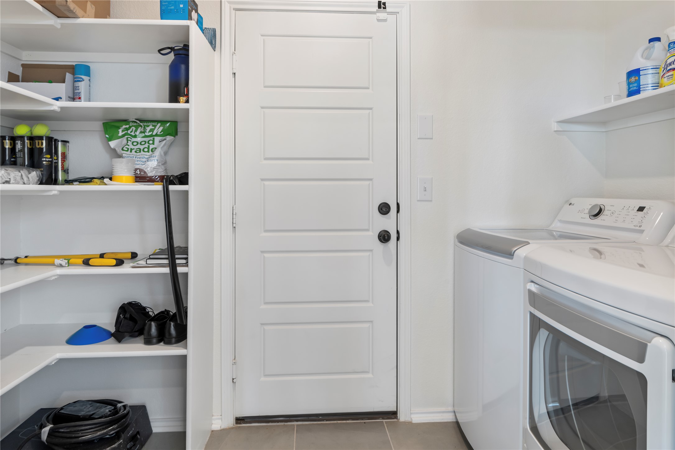 18501 Spotted Eagle Lane Elgin, TX 78621 - Photo 33 of 40 Laundry room with separate washer and dryer and light tile patterned flooring