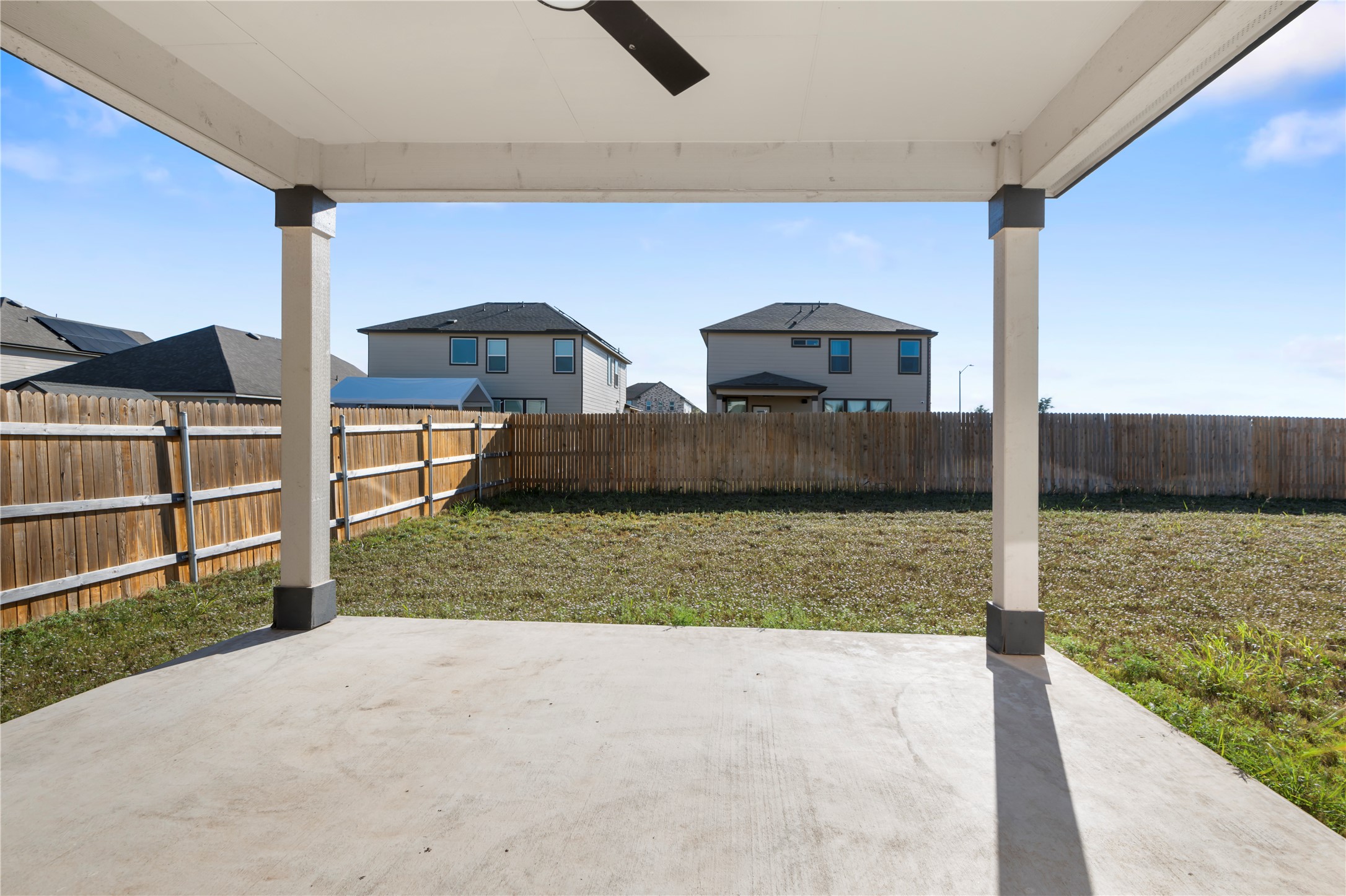 18501 Spotted Eagle Lane Elgin, TX 78621 - Photo 36 of 40 Fenced backyard featuring a patio area, ceiling fan, and a residential view