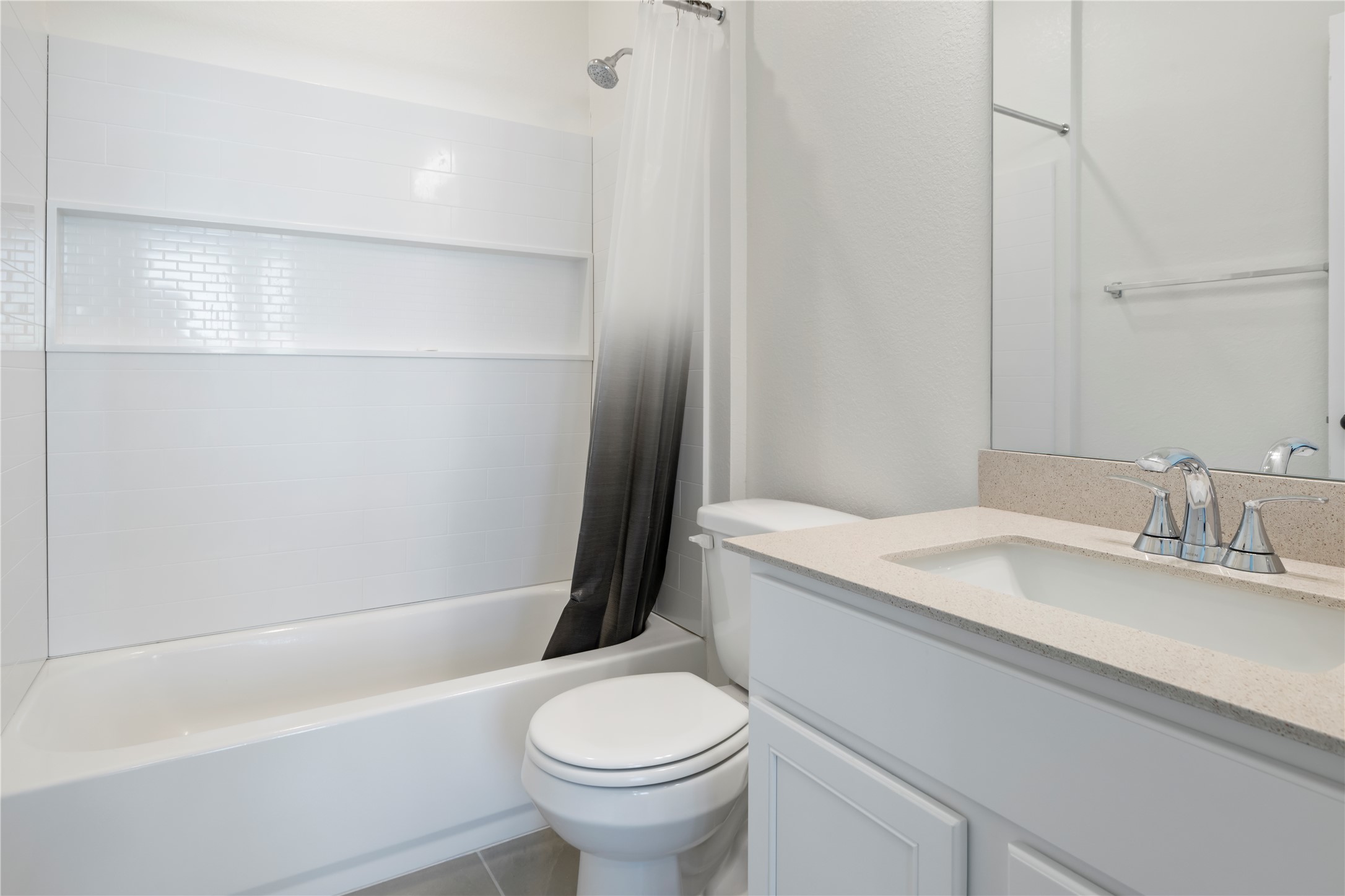 18501 Spotted Eagle Lane Elgin, TX 78621 - Photo 37 of 40 Bathroom featuring shower / bathtub combination with curtain, vanity, and tile patterned floors