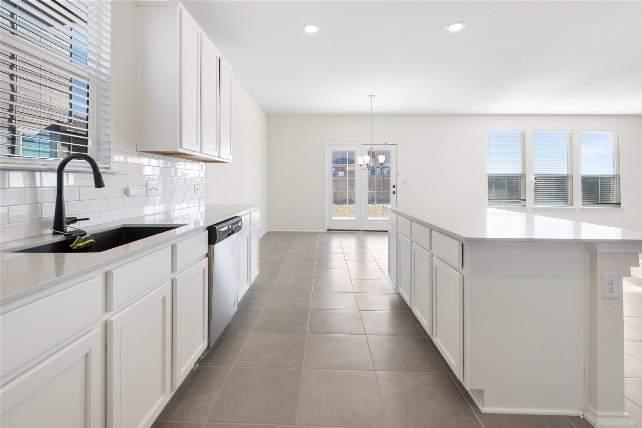 18501 Spotted Eagle Lane Elgin, TX 78621 - Photo 5 of 40 Kitchen with white cabinetry, healthy amount of natural light, and a center island