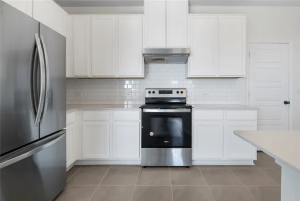 a kitchen with stainless steel appliances a stove and a refrigerator