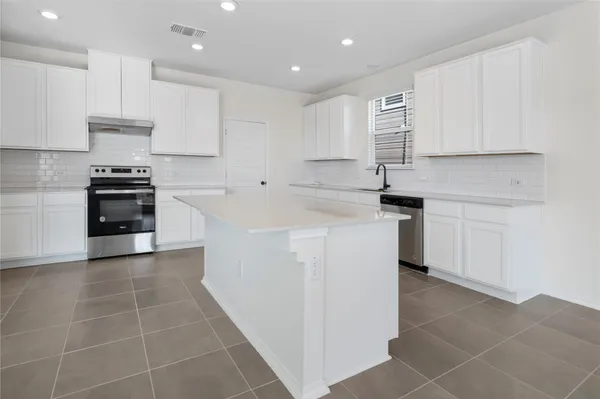 a kitchen with stainless steel appliances granite countertop a sink and cabinets