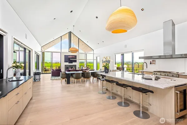 a dining room with furniture a flat screen tv and a large window
