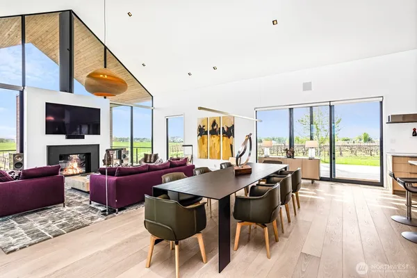 a living room with furniture a fireplace and a floor to ceiling window