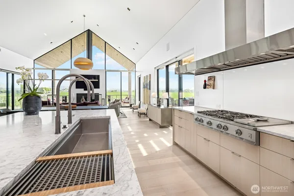 a kitchen with a sink a stove and cabinets