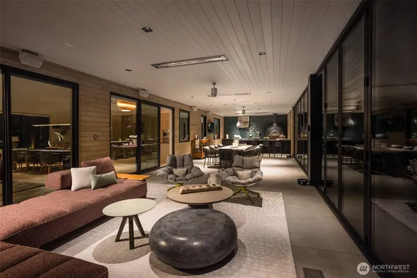 a living room with furniture large window and a fireplace