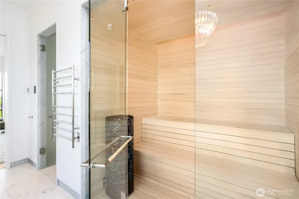 a bathroom with a glass shower door