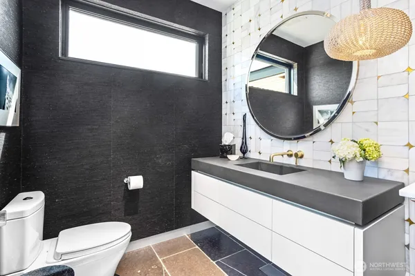 a bathroom with a double vanity sink toilet and a tub