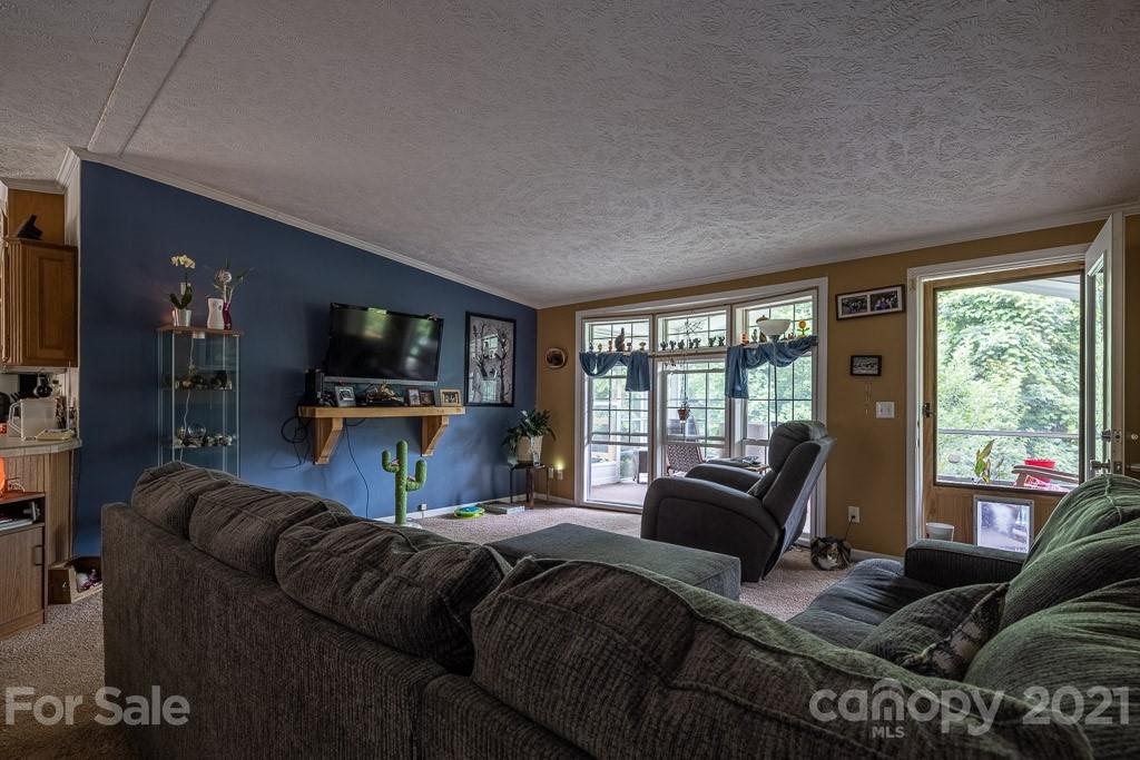 47 Integrity Mountain Otto, NC 28763 - Photo 11 of 22 a bedroom with a bed and glass windows