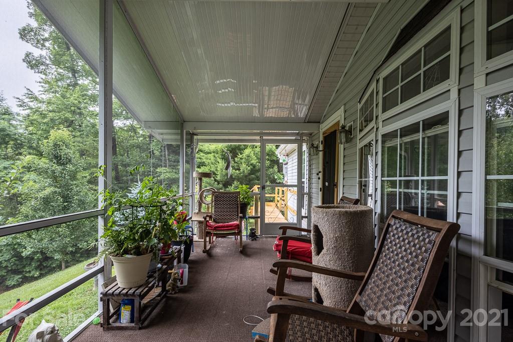 47 Integrity Mountain Otto, NC 28763 - Photo 14 of 22 a view of a porch with furniture and garden