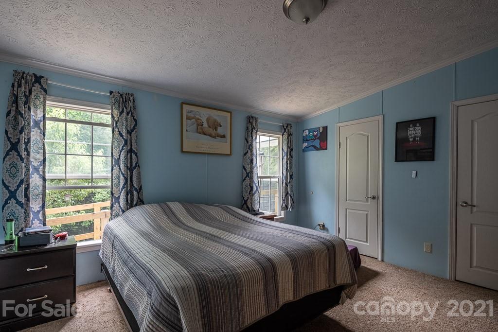 47 Integrity Mountain Otto, NC 28763 - Photo 16 of 22 a bedroom with a bed and a window