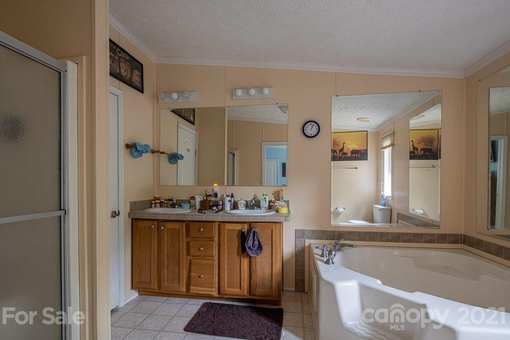 47 Integrity Mountain Otto, NC 28763 - Photo 17 of 22 a bathroom with a tub sink and mirror