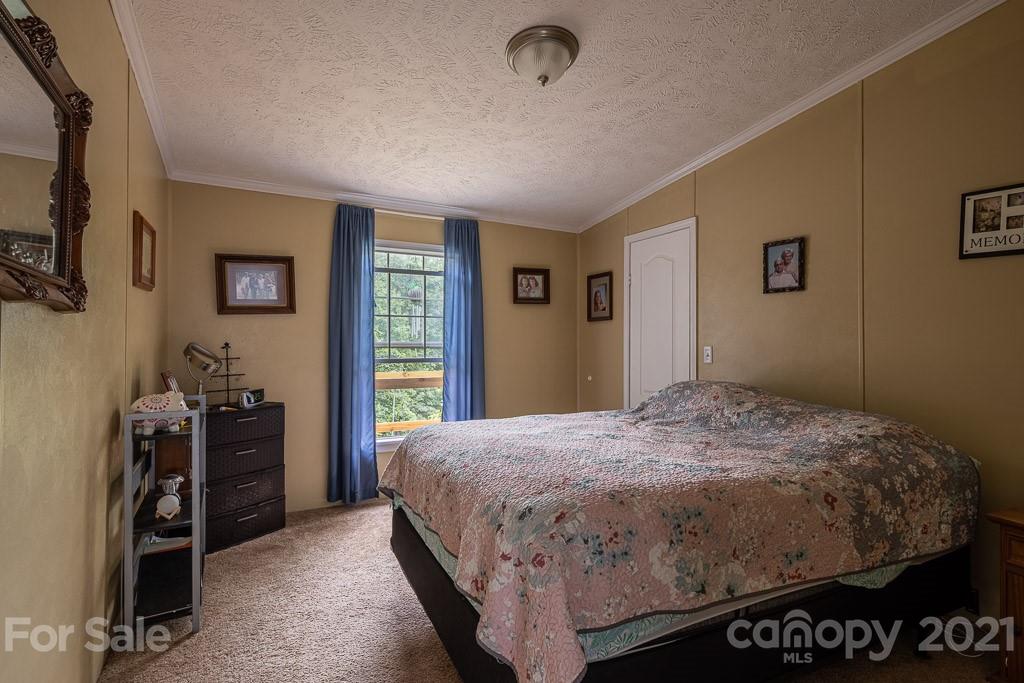 47 Integrity Mountain Otto, NC 28763 - Photo 7 of 22 a bedroom with a bed and a walk in closet