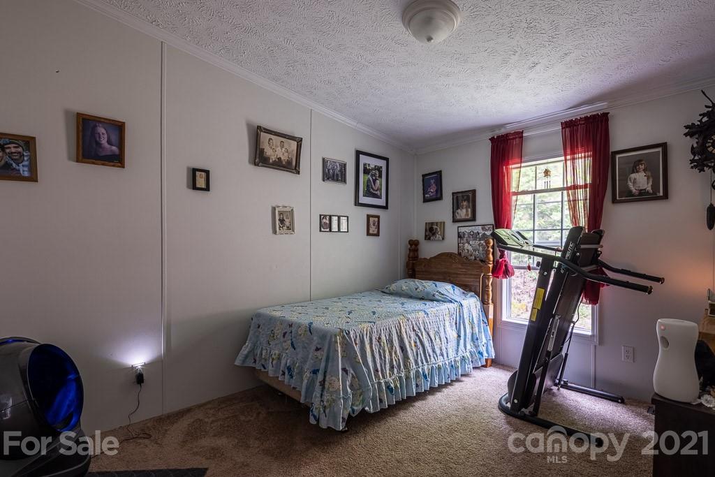47 Integrity Mountain Otto, NC 28763 - Photo 8 of 22 a bedroom with a bed and wooden floor