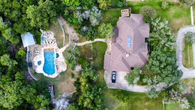 an aerial view of residential house with outdoor space and swimming pool