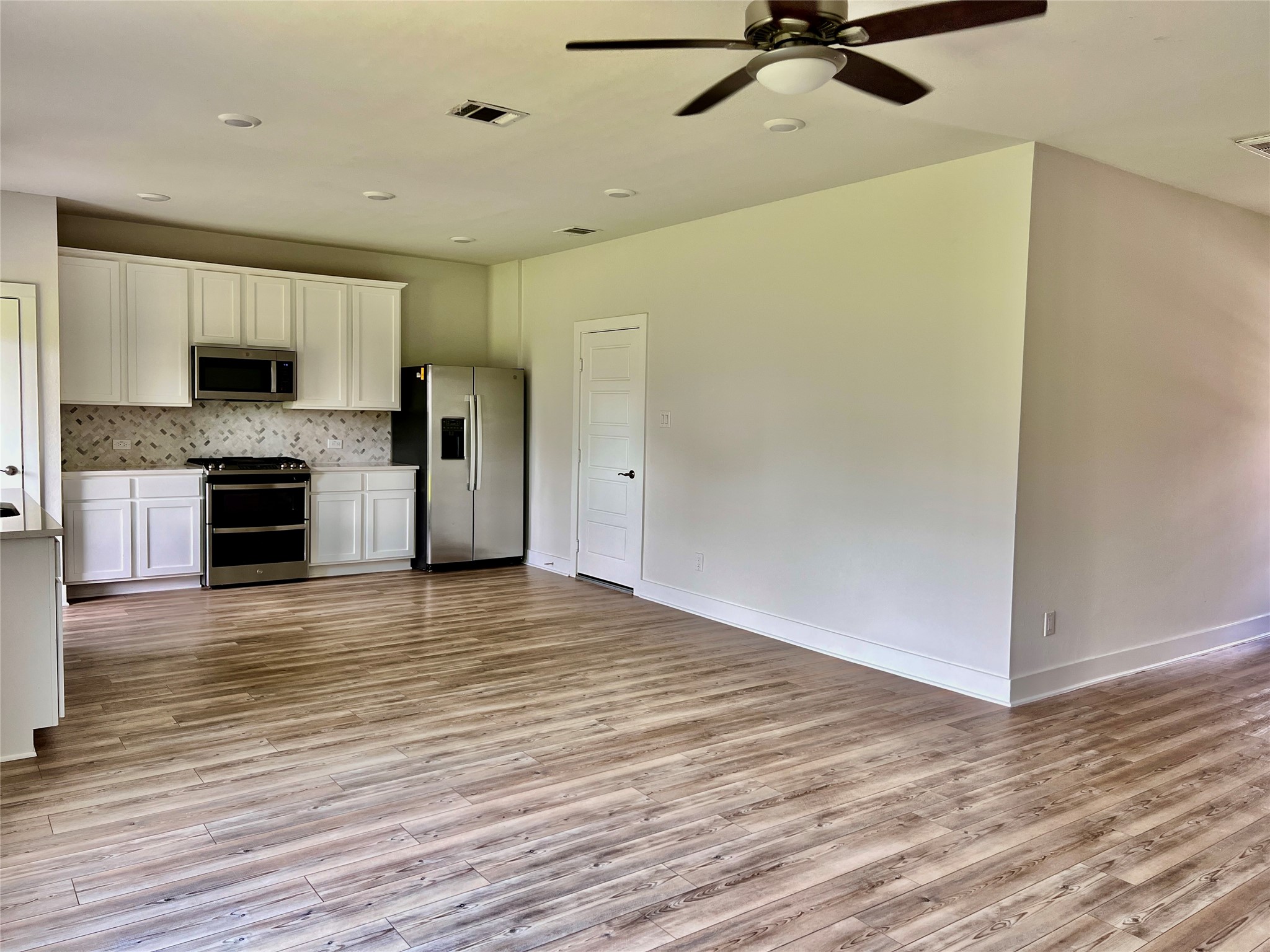 10638 Whitejacket Conroe, TX 77385 - Photo 18 of 25 a view of a kitchen with a sink and a refrigerator