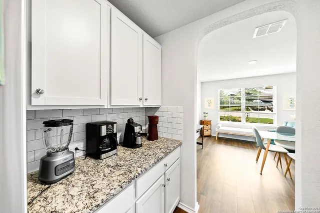 a kitchen with stainless steel appliances granite countertop a sink stove and cabinets