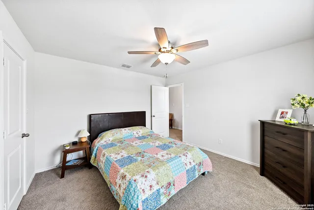 a bedroom with furniture and a large window