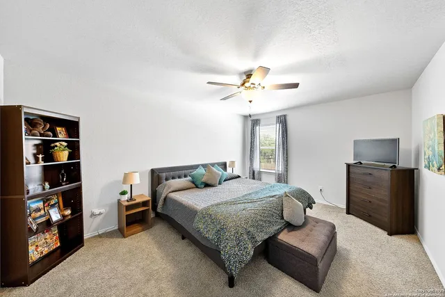 a bedroom with a bed and dresser with mirror