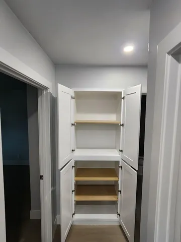 a view of kitchen with refrigerator and a couch