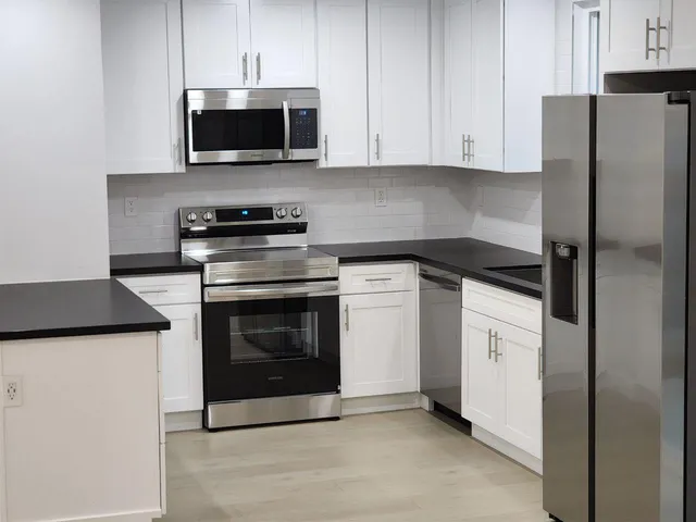 a kitchen with a stove and a microwave