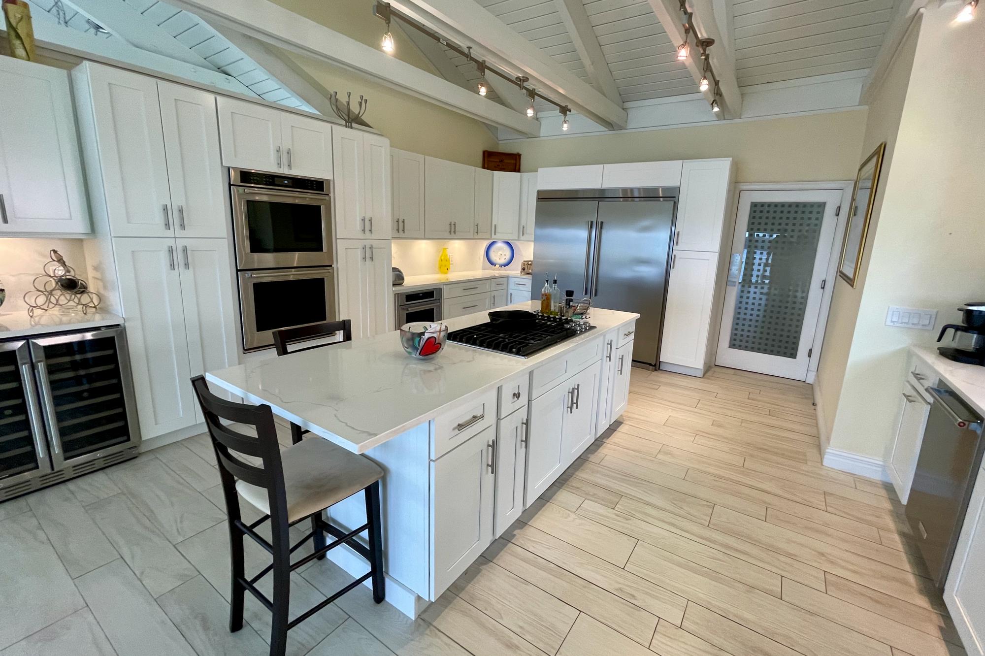 4040 Northeast Joes Point Road Stuart, FL 34996 - Photo 11 of 35 a kitchen with stainless steel appliances a sink a stove a refrigerator and cabinets
