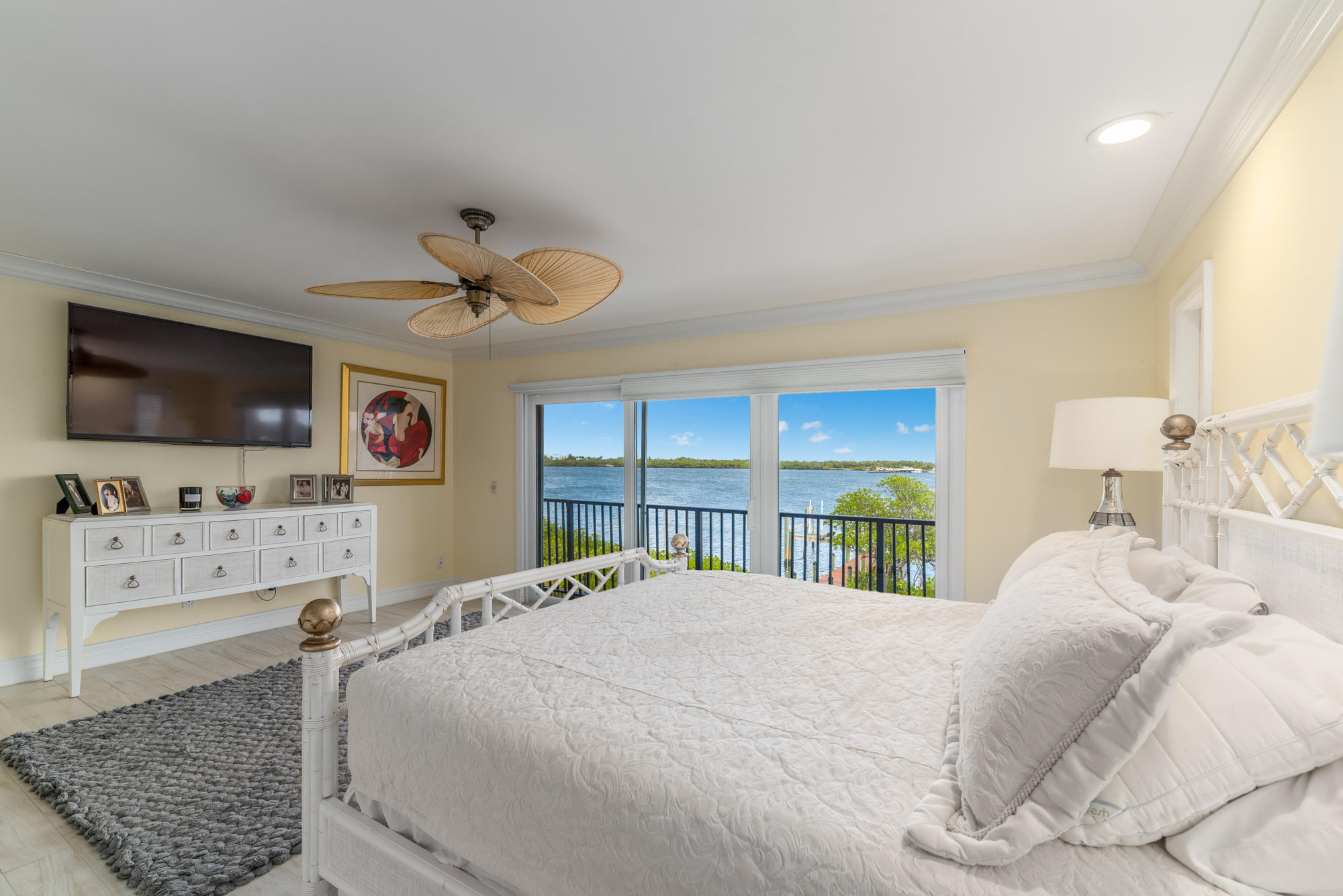 4040 Northeast Joes Point Road Stuart, FL 34996 - Photo 13 of 35 a bedroom with a bed and a flat screen tv