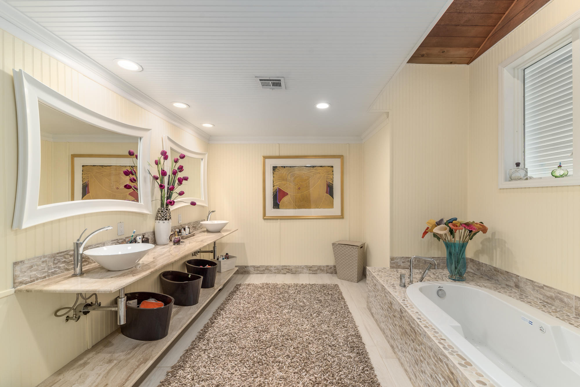 4040 Northeast Joes Point Road Stuart, FL 34996 - Photo 14 of 35 a spacious bathroom with a tub double vanity and a window