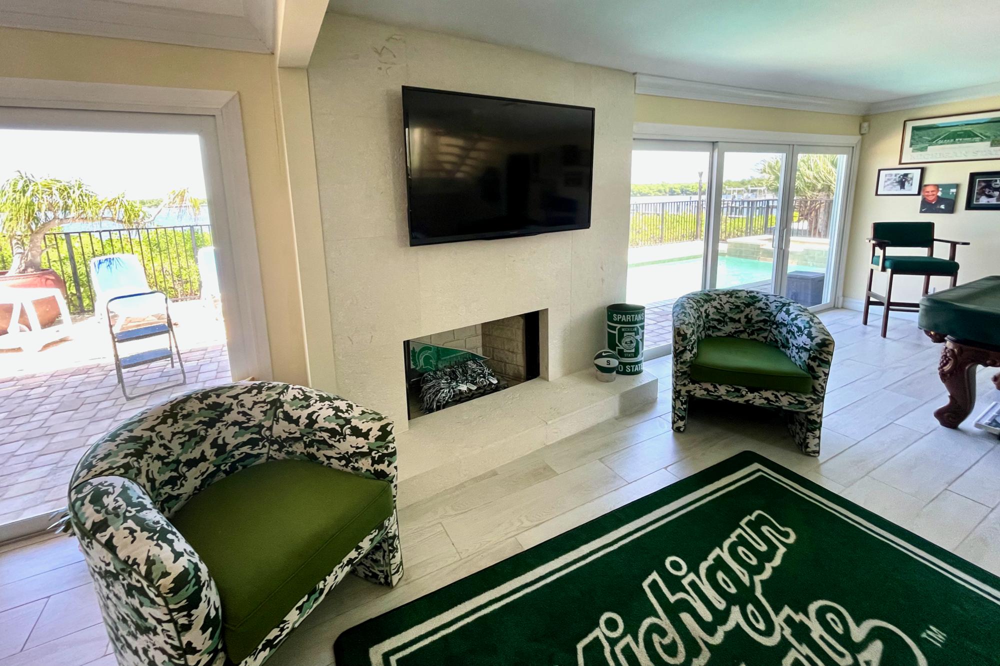 4040 Northeast Joes Point Road Stuart, FL 34996 - Photo 18 of 35 a living room with furniture and a flat screen tv