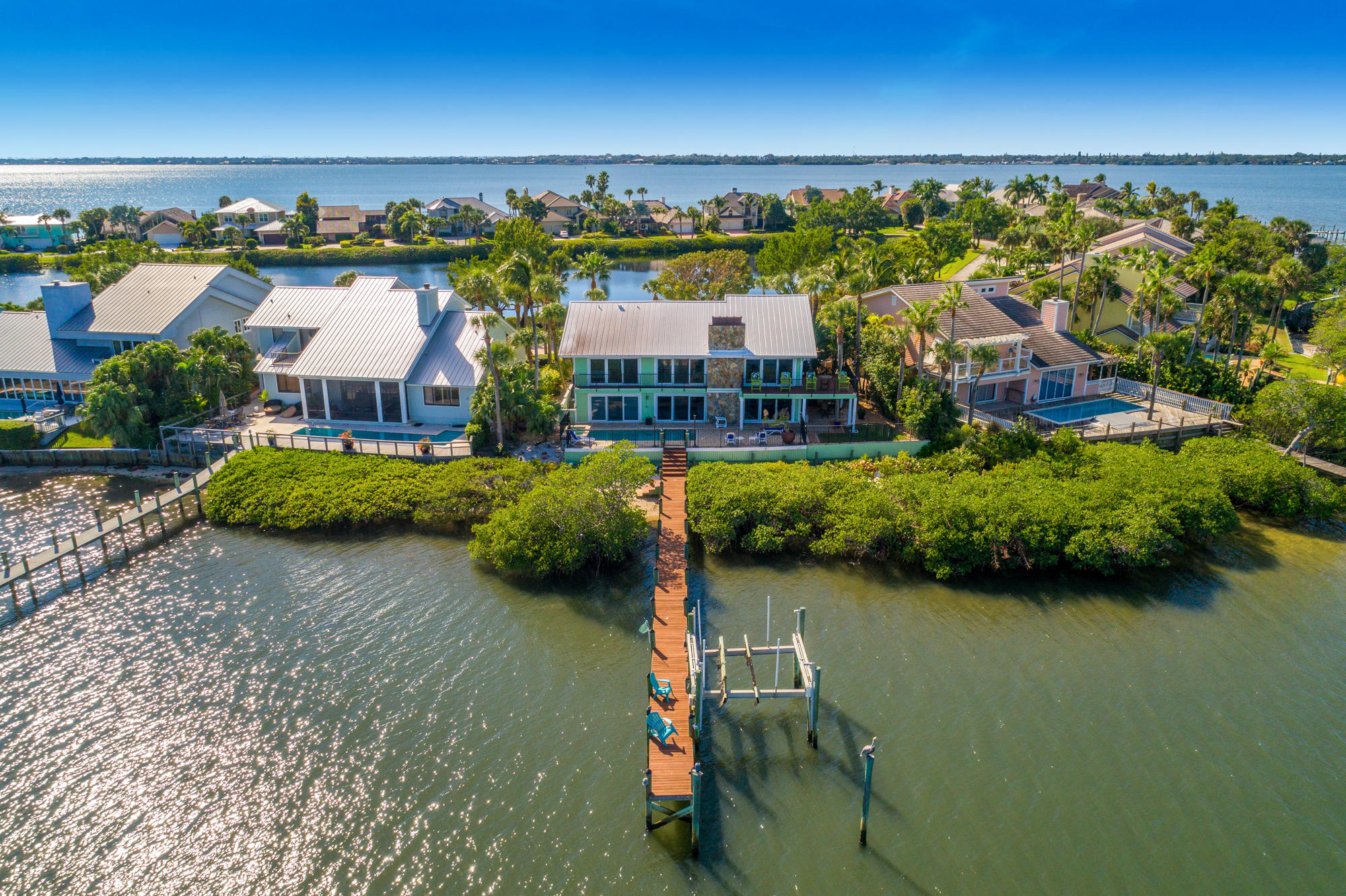 4040 Northeast Joes Point Road Stuart, FL 34996 - Photo 2 of 35 an aerial view of residential building with outdoor space and lake view
