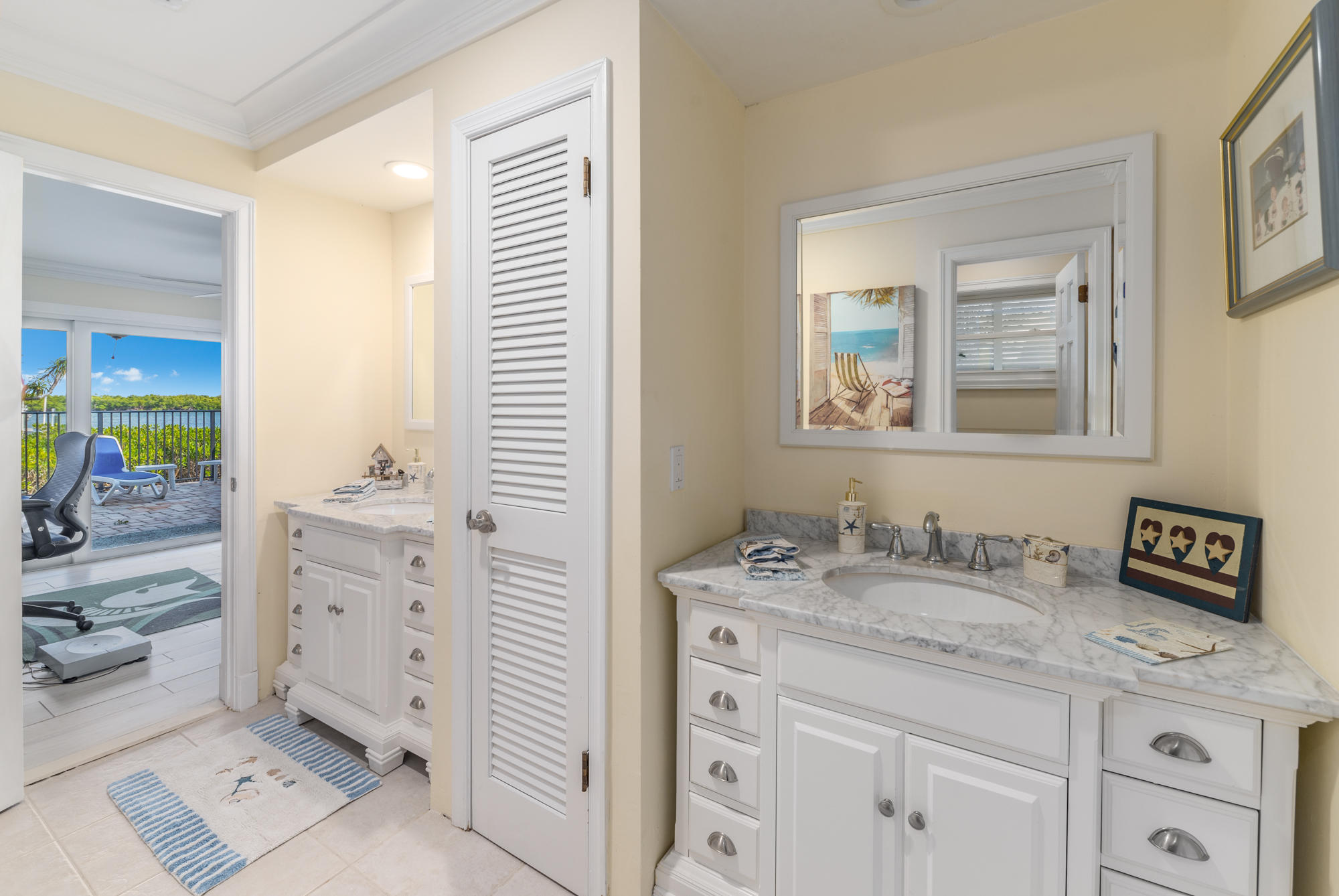 4040 Northeast Joes Point Road Stuart, FL 34996 - Photo 22 of 35 a bathroom with a sink a vanity and a mirror