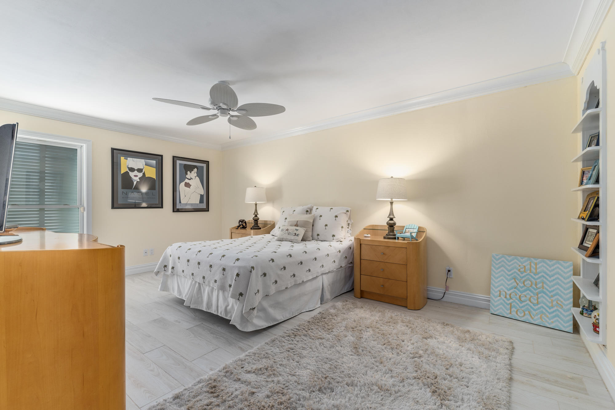 4040 Northeast Joes Point Road Stuart, FL 34996 - Photo 27 of 35 a spacious bedroom with a bed and a chandelier