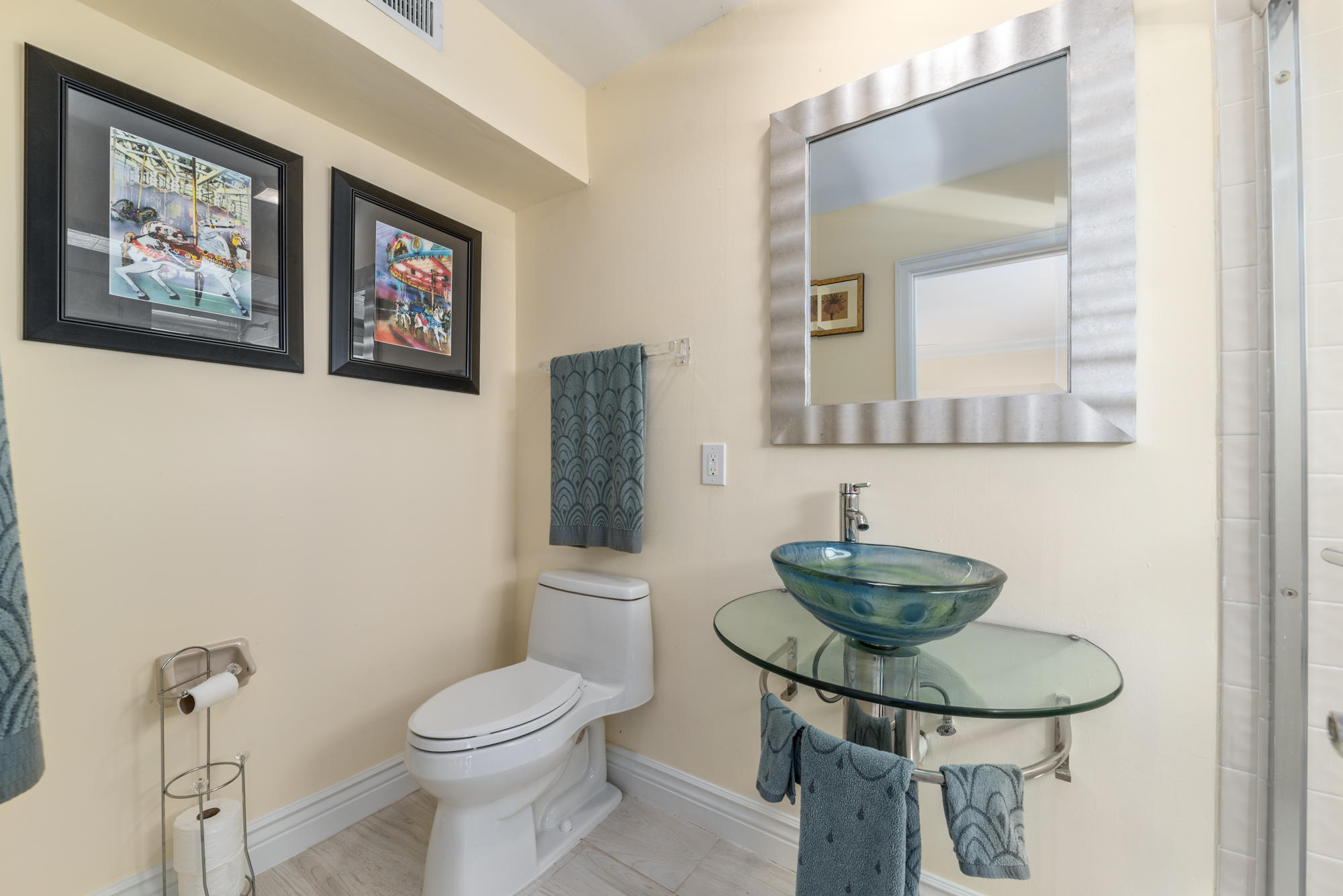 4040 Northeast Joes Point Road Stuart, FL 34996 - Photo 28 of 35 a bathroom with a toilet a sink and mirror