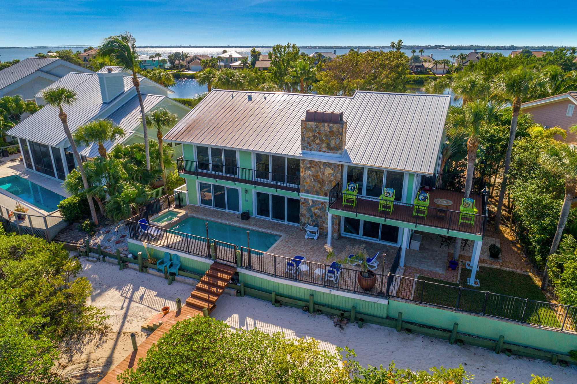 4040 Northeast Joes Point Road Stuart, FL 34996 - Photo 3 of 35 an aerial view of a house with swimming pool a yard and lake view