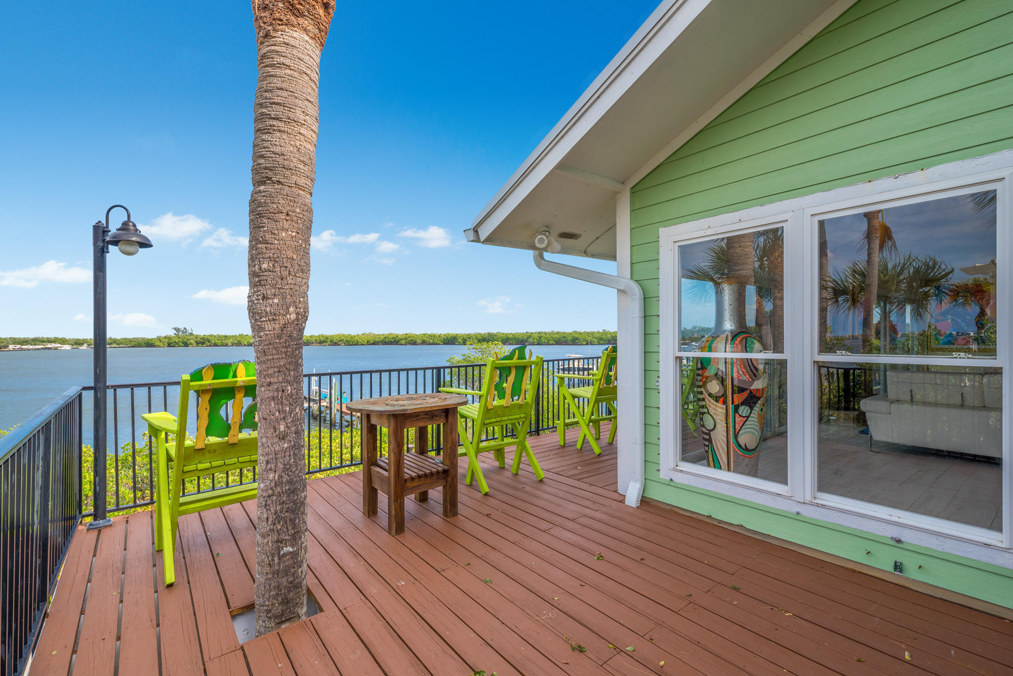 4040 Northeast Joes Point Road Stuart, FL 34996 - Photo 31 of 35 a view of a balcony with chairs and wooden floor