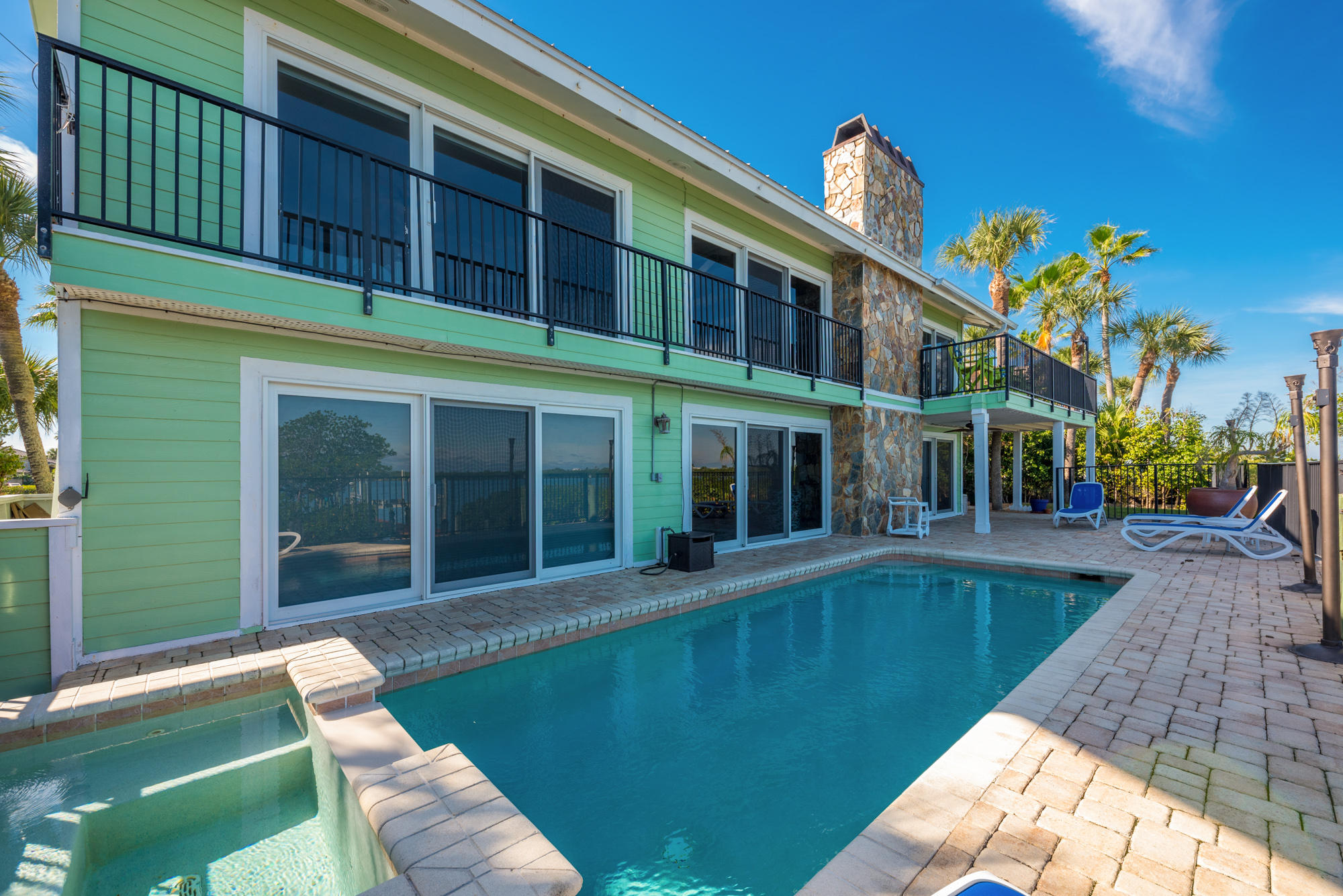 4040 Northeast Joes Point Road Stuart, FL 34996 - Photo 32 of 35 a view of a house with a swimming pool
