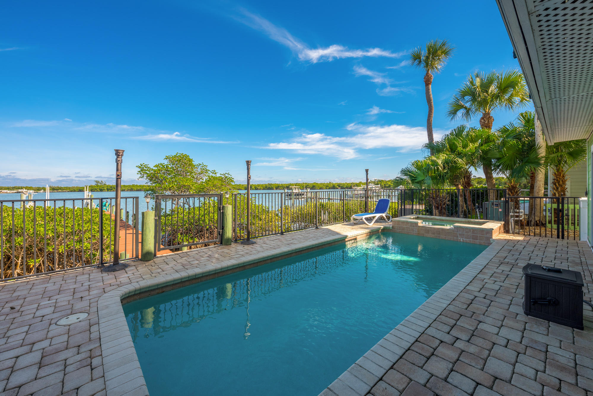 4040 Northeast Joes Point Road Stuart, FL 34996 - Photo 33 of 35 a view of a swimming pool with a patio