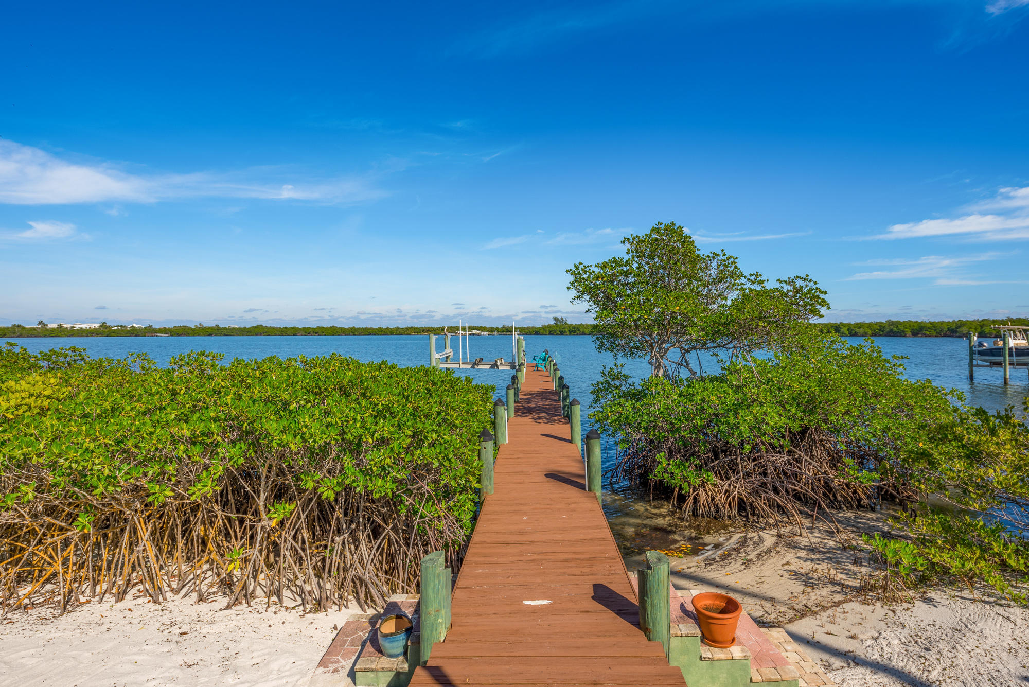 4040 Northeast Joes Point Road Stuart, FL 34996 - Photo 34 of 35 a view of a pathway with a wooden fence