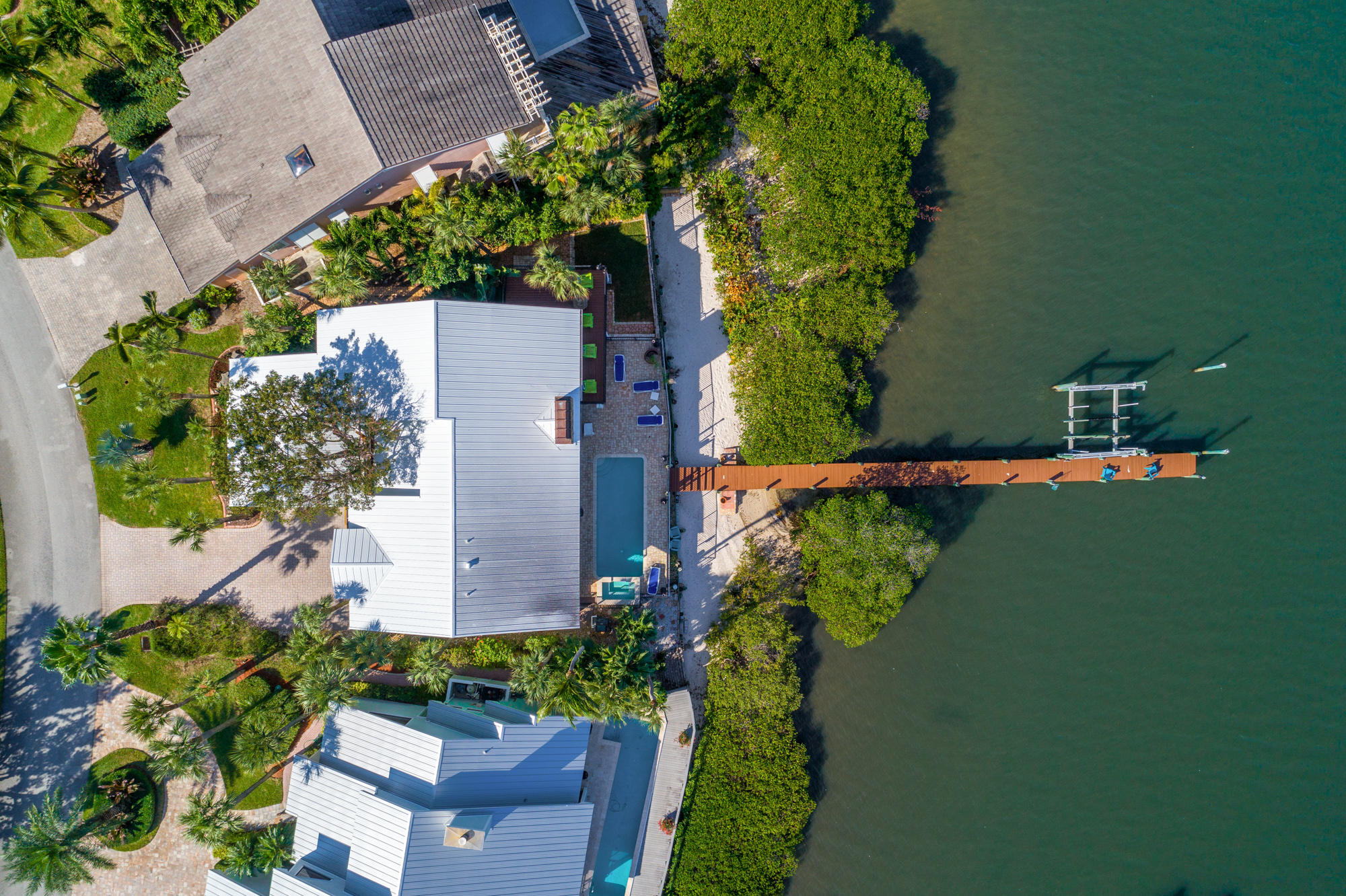 4040 Northeast Joes Point Road Stuart, FL 34996 - Photo 4 of 35 an aerial view of a house with a yard lake and outdoor seating