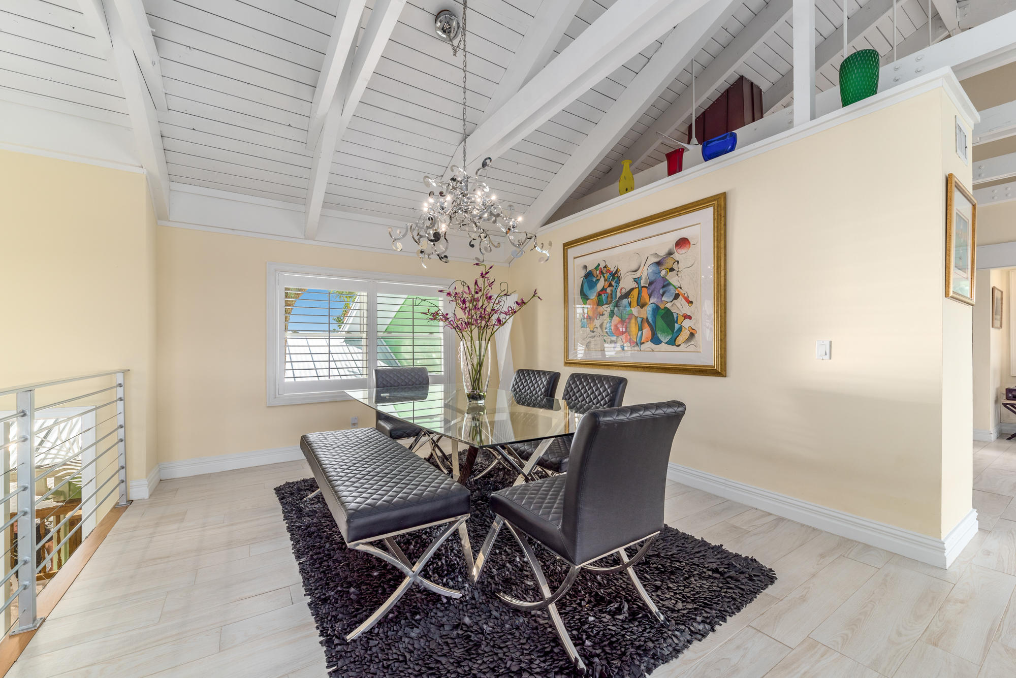 4040 Northeast Joes Point Road Stuart, FL 34996 - Photo 9 of 35 a dining room with furniture a rug and a chandelier