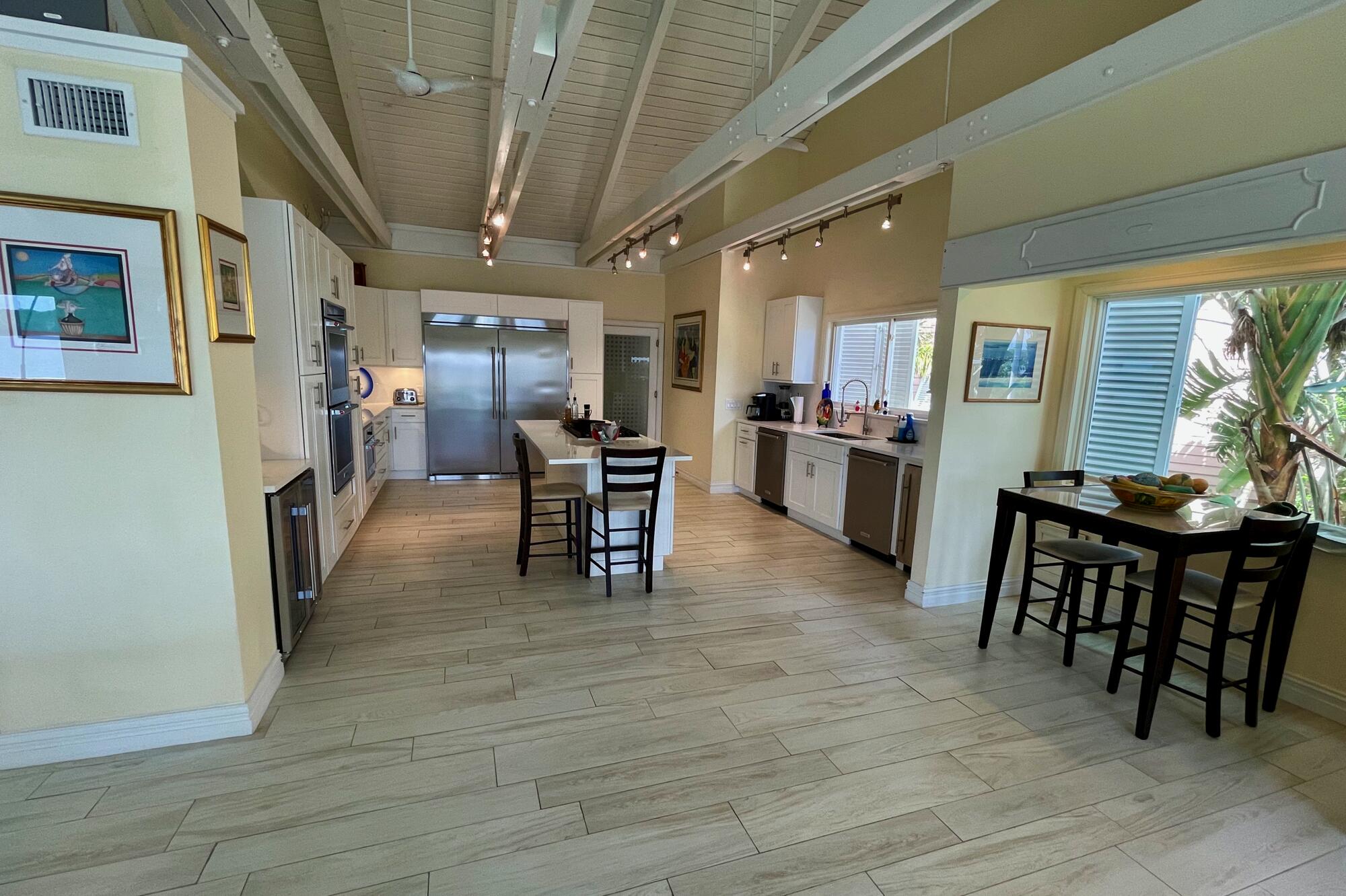 4040 Northeast Joes Point Road Stuart, FL 34996 - Photo 10 of 35 a dining room with furniture and large windows