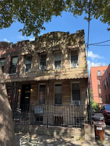 a view of a building with a window and a tree