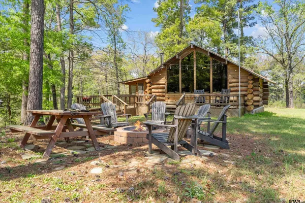 a view of a house with backyard and sitting area
